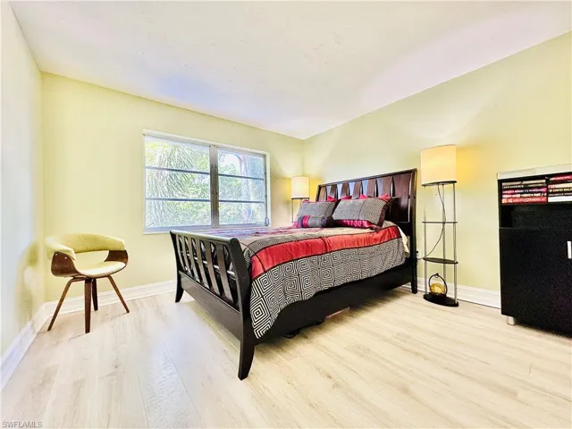 Bedroom featuring light wood-type flooring and baseboards