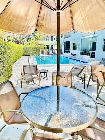 Community pool with a patio area and a gazebo
