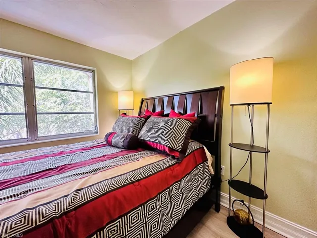 Bedroom with baseboards and wood finished floors