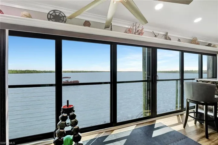Sunroom featuring endless water views