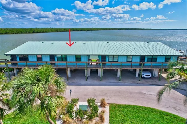 Aerial view front of building featuring landscaped common area