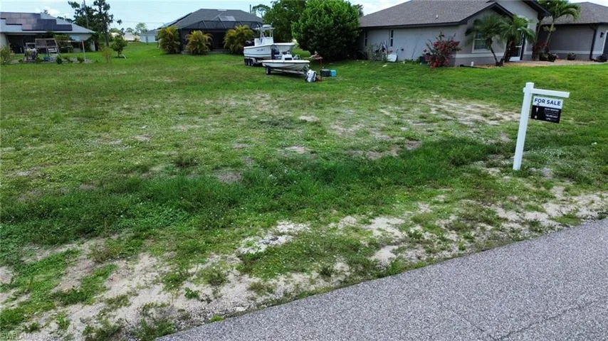 Expansive residential lot featuring a paved road frontage
