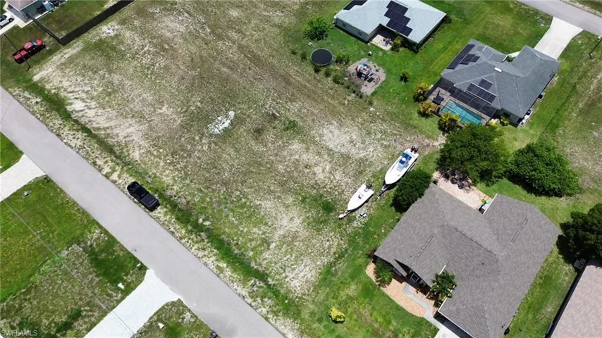 Expansive cleared lot bordering a paved road, offering substantial space for construction