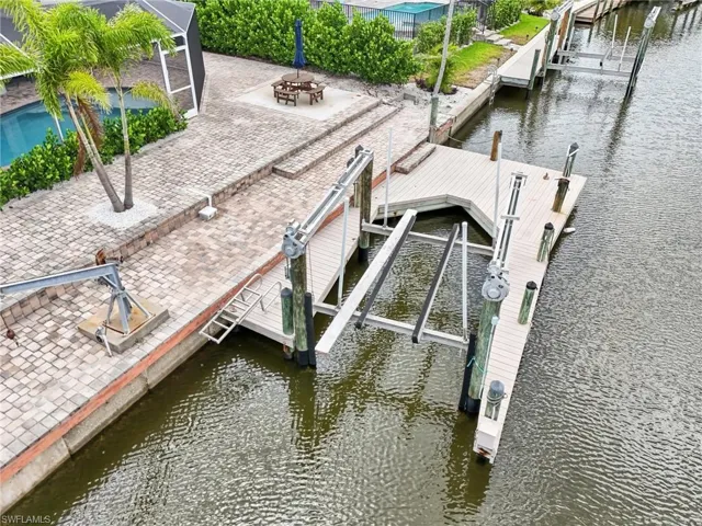 Dock area with a water view and a patio