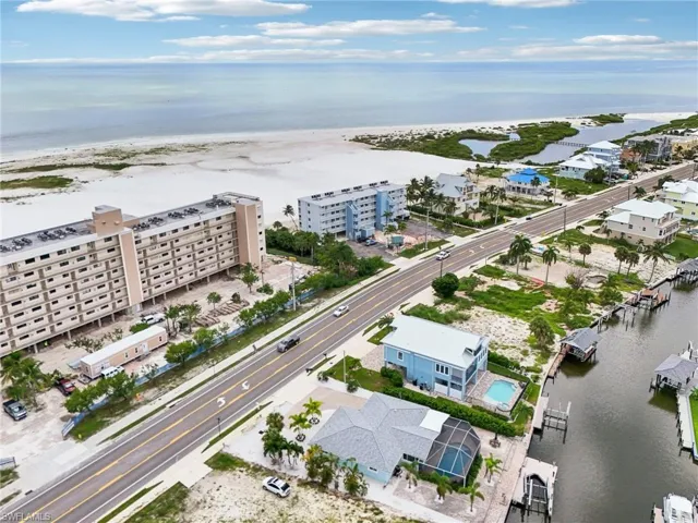Aerial view featuring a beach view and a water view