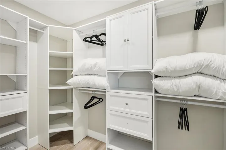 Spacious closet featuring light hardwood / wood-style flooring