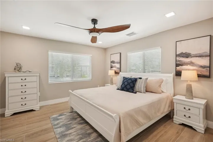 Bedroom with ceiling fan and light hardwood / wood-style floors