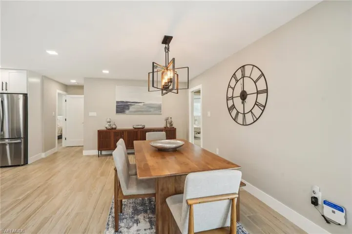 Dining room with a notable chandelier and light wood-type flooring