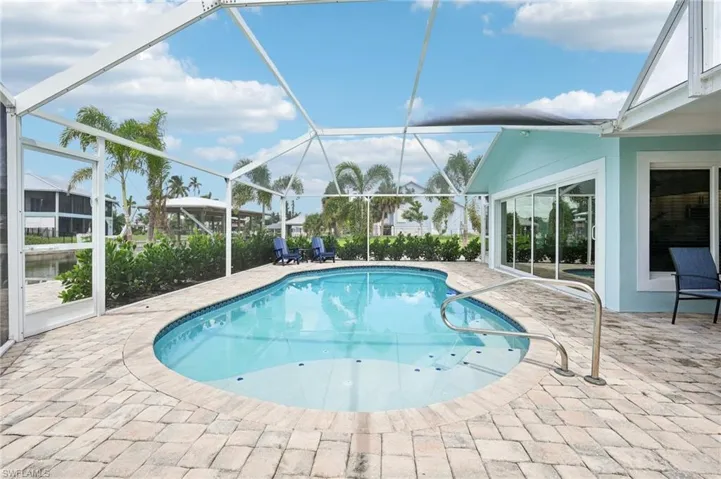 View of pool with a lanai and a patio area