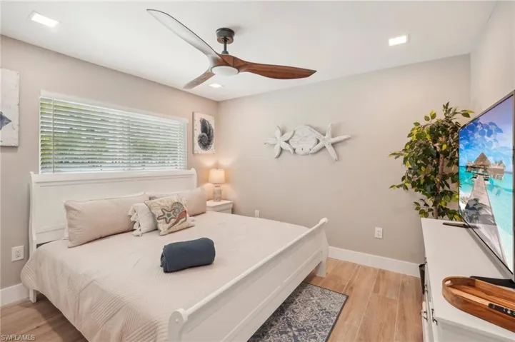 Bedroom with ceiling fan and light hardwood / wood-style floors
