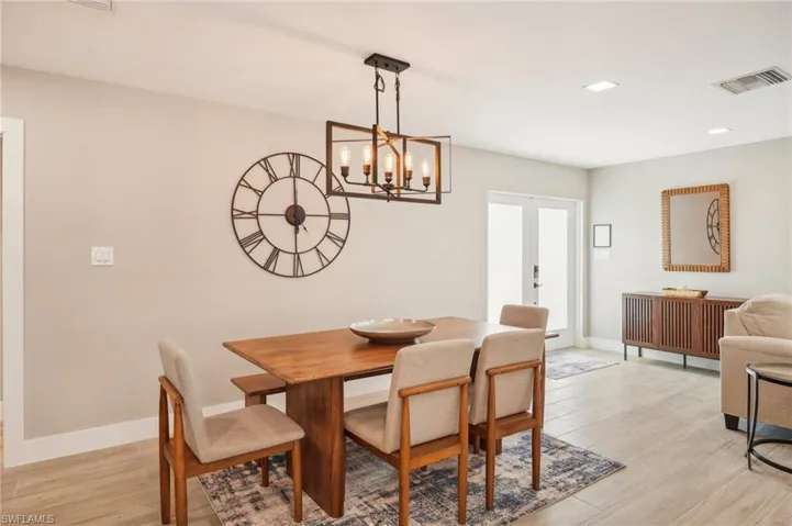 Dining room with a notable chandelier and light hardwood / wood-style floors