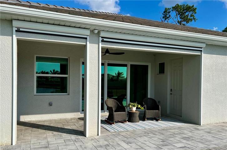 Covered lanai with cabana bathroom and retractable screen enclosure