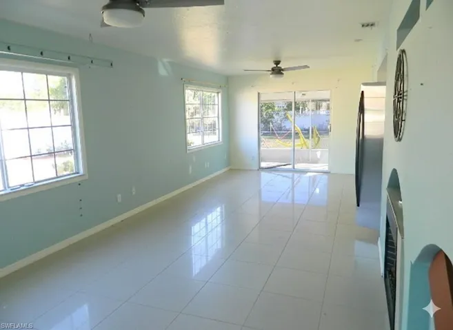 Spare room featuring tile patterned floors and a ceiling fan