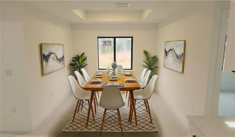 Dining area featuring a tray ceiling