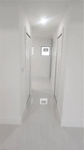 hall to primary bath, 2 walk in closets