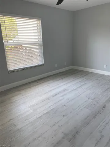 Unfurnished room with light wood finished floors and ceiling fan