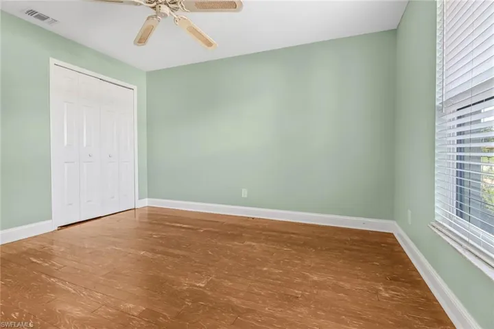 Spare room featuring hardwood / wood-style floors and ceiling fan