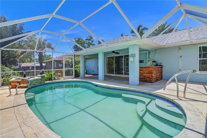View of pool with a patio, and ceiling fan, and built in kitchen