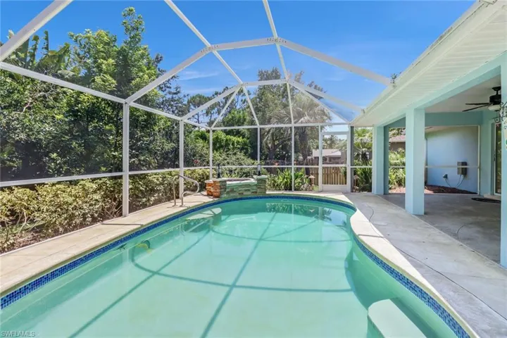 View of swimming pool featuring a patio, a lanai, and ceiling fan