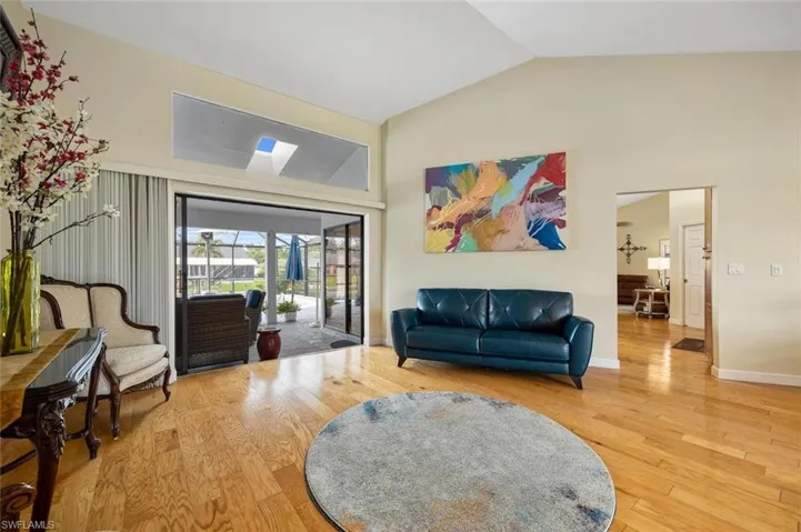 Living area featuring wood finished floors and high vaulted ceiling