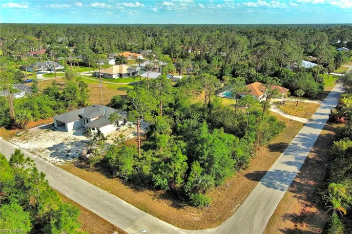 Aerial view of residential area featuring a heavily wooded area