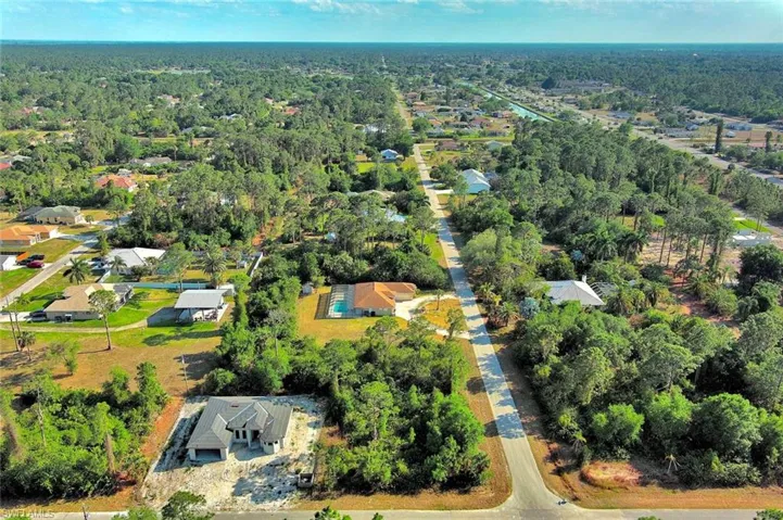 Aerial view of property's location with nearby suburban area