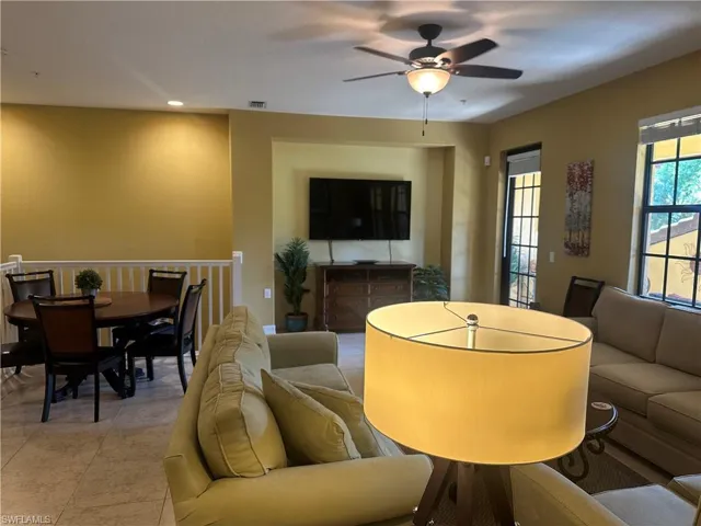 Living room featuring a ceiling fan and light tile patterned flooring