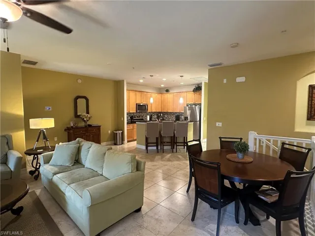 Living room featuring light tile patterned flooring, recessed lighting, and ceiling fan