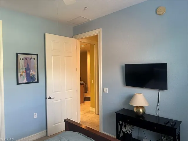 Bedroom with baseboards and light tile patterned flooring