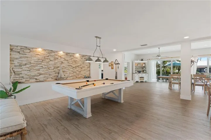 Recreation room featuring ceiling fan, billiards, and light wood look tile floors