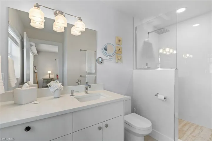 Bathroom with vanity, toilet, and walk in shower