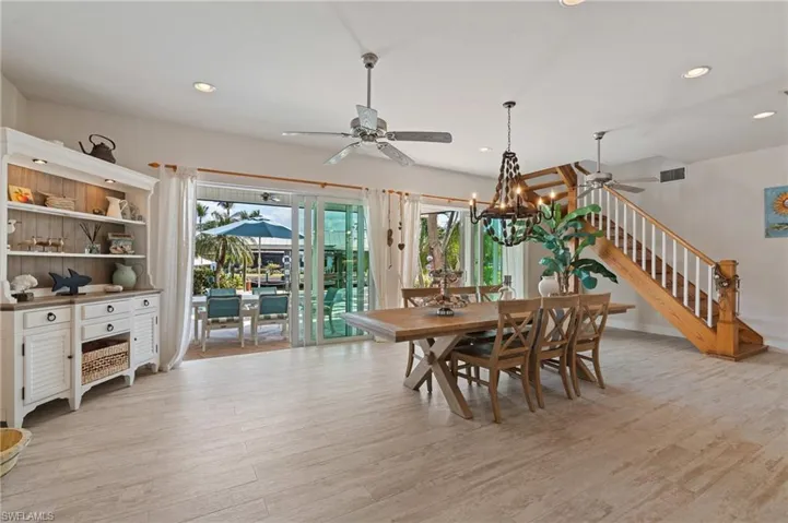 Dining room with ceiling fan and lightwood look tile flooring