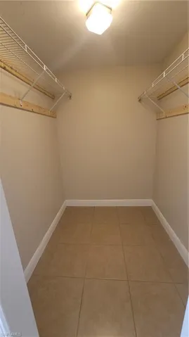 Walk in closet featuring light tile patterned floors