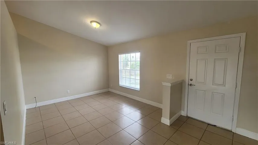 Unfurnished room with baseboards and light tile patterned floors