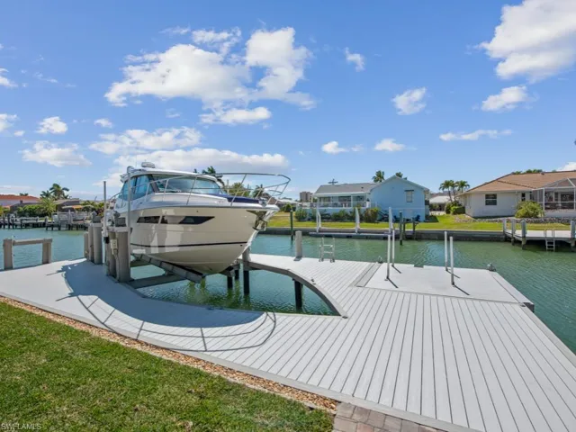 Dock area featuring a water view, a residential view, and boat lift