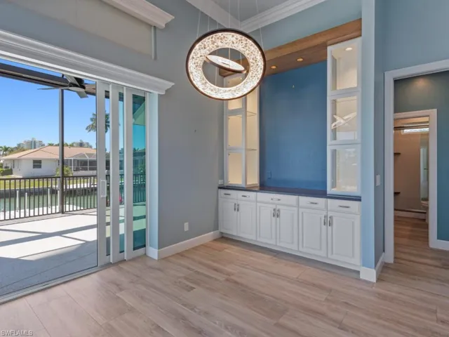 Unfurnished dining area featuring a water view, baseboards, light wood-style floors, and baseboard heating