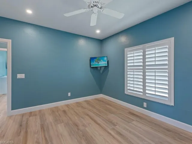 Unfurnished room with baseboards, wood finished floors, and ceiling fan