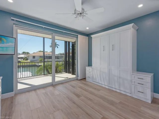 Unfurnished bedroom featuring light wood-style floors, baseboards, access to outside, and recessed lighting