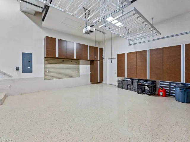 Garage with electric panel and a garage door opener