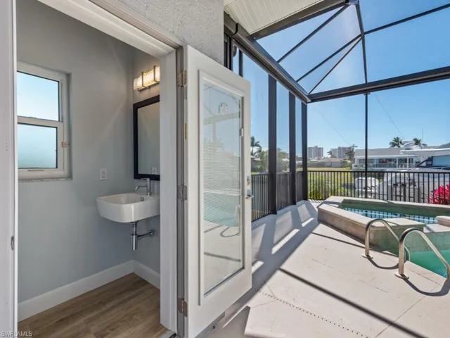 Sunroom featuring a sink