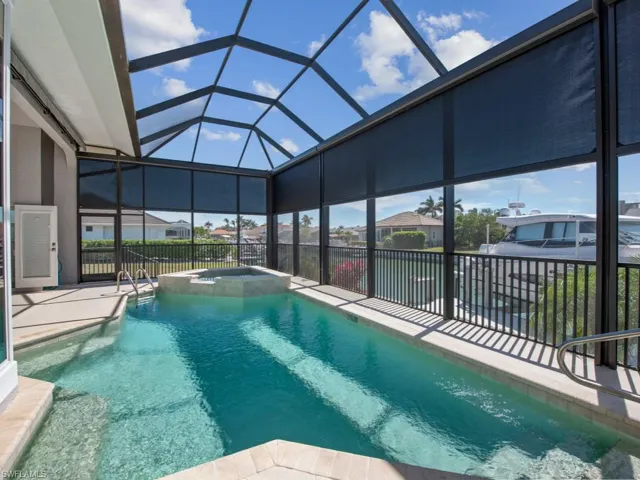 View of pool featuring a pool with connected hot tub, a lanai, and a patio