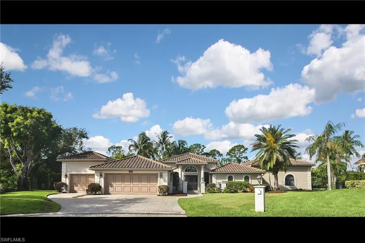 Mediterranean / spanish home featuring a garage and a front lawn