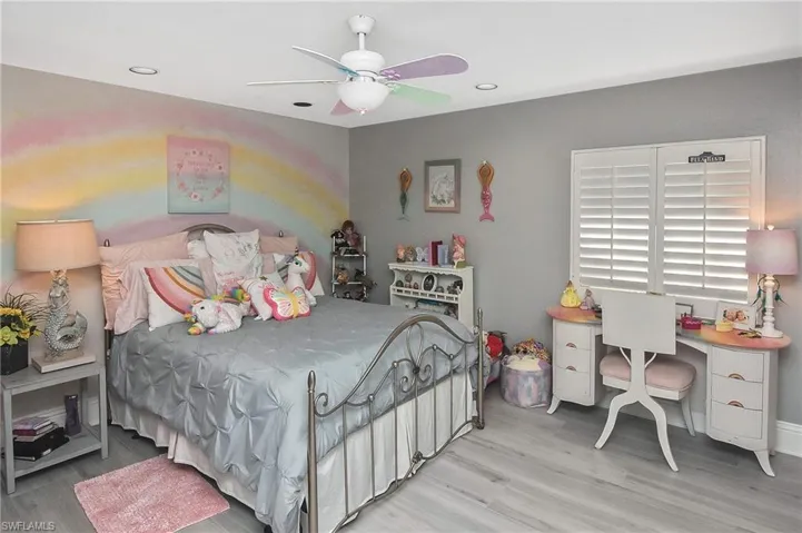 Bedroom with light hardwood / wood-style flooring and ceiling fan