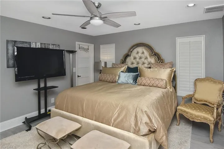 Bedroom with hardwood / wood-style flooring and ceiling fan