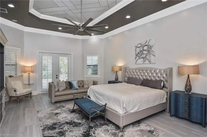 Bedroom featuring ceiling fan, access to outside, hardwood / wood-style flooring, and ornamental molding