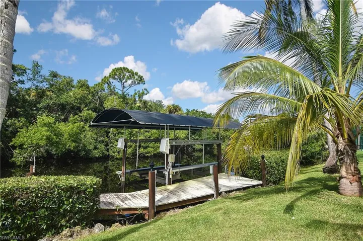 Dock area with a yard and a wooden deck