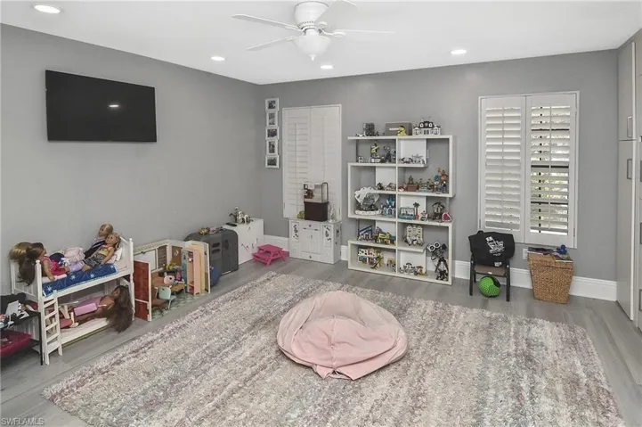 Rec room with light wood-type flooring and ceiling fan
