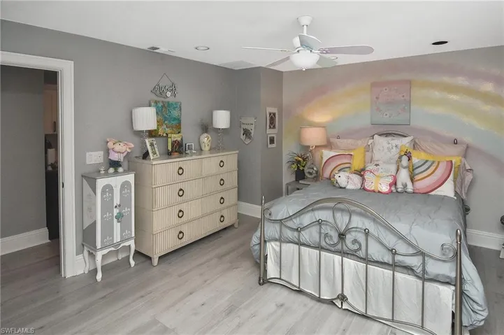 Bedroom with light hardwood / wood-style flooring and ceiling fan