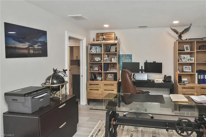 Office area with light hardwood / wood-style flooring