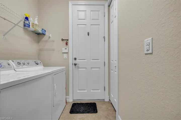 Located in back hallway with door to garage